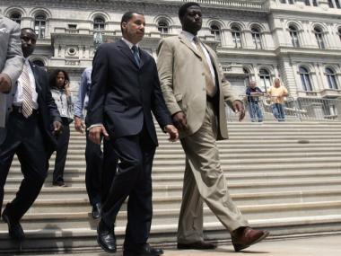 Gov. David Paterson, left, and aide David Johnson walk down the steps of the Capitol in Albany.