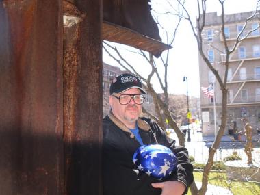 Keith Lebow at the 9/11 Memorial at the Good Shepherd Church in Inwood. The cross is made out of iron from the World Trade Center.