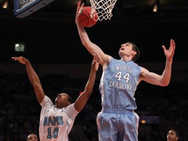 North Carolina's Tyler Zeller (r.) grabs a rebound over Rhode Island's Akeem Richmond (l.) at Madison Square Garden on March 30.