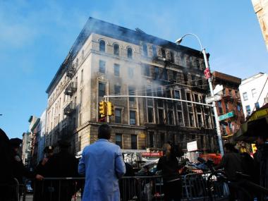 Smoke was still billowing from the windows of a building destroyed in a Chinatown fire. April 12, 2010