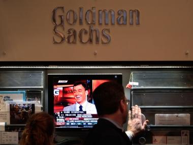 Financial professionals work in the Goldman Sachs booth on the floor of the New York Stock Exchange.