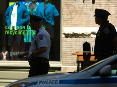 Police officers outside 101 Wooster St.
