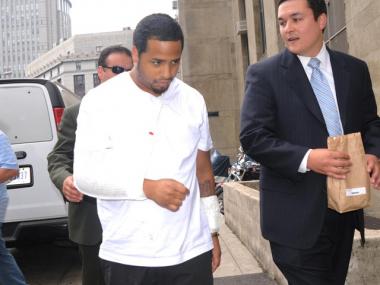 Angel Alvarez, who was shot 21 times by police in a Harlem shootout, was walked into Manhattan Criminal Court on Monday for his arraignment on gun possession charges.