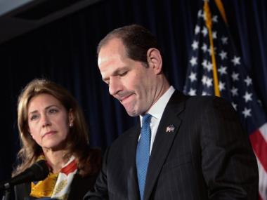 New York Gov. Eliot Spitzer (R) announces his resignation as his wife Silda stands next to him March 12, 2008.