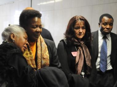 Tumi McCallum's mother, Teboho Moja, second from left, grieves with family members outside court Wednesday.