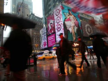 Pedestrians walk past the corner of 42nd Street and 7th Avenue in Times Square on Monday morning. The area resumed normal operations, with increased police presence, after a car bomb was discovered on Saturday evening May 1 before it could be detonated.