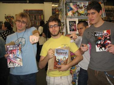 Three students from the School of Visual Arts celebrate their stash of free comics with their best Green Lantern poses.