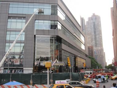 A work crew removed broken glass from a Time Warner Center window frame on Friday.
