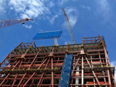 Workers installed the panels of steel and netting to the top of the tower and will soon install more netting below.