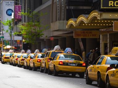 Taxis waiting for fares line a Midtown block.