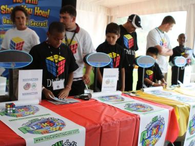Queens student Simkho Saimono, 9, works on cracking the cube's code.