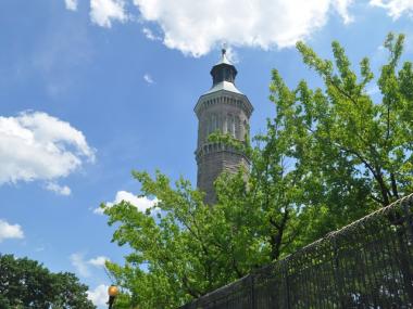 The pool is situated next door to the Harlem River and Highbridge Park, with its tower looming over the grounds.
