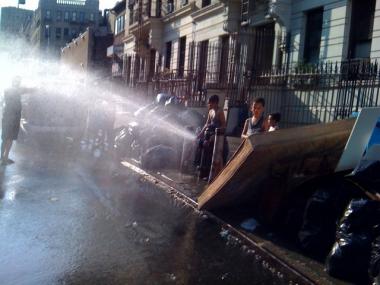 Boys playfully sprayed water from a fire hydrant as they tried to cool off in the record breaking heat.
