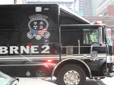 A New York City Department of Environmental Protection Haz-Mat truck parked outside of 441 Ninth Ave. while police and fire department officials evacuated the building.