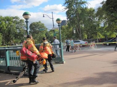 EMTs enter the subway station at W. 110th Street and Lenox Avenue on Thursday.