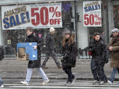 Shoppers make their way in the snow in Union Square, Sunday, Dec. 26, 2010 in New York.