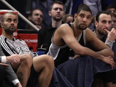 Spurs guards Tony Parker, left and Manu Ginobili, right, flank center Tim Duncan, sitting on the bench in the waning moments of the Spurs 128-115 loss to the New York Knicks at Madison Square Garden on Jan. 4, 2011.