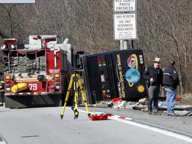 Investigators work to find the cause of a bus crash which killed at 15 in the Bronx on March 12, 2011.