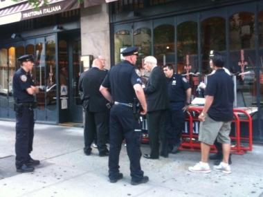 Police officers respond to a scene where a man allegedly tried to grab a gun out of a cop's holster.