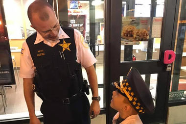 Cmdr. Roberto Nieves of the Rogers Park Police Department outside Dunkin' Donuts in Rogers Park during a positive loitering event recently.
