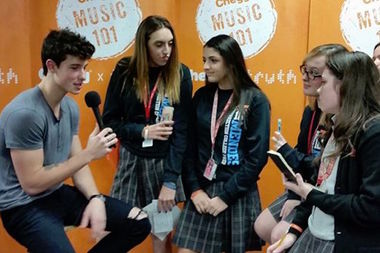 Singer Shawn Mendes talks to students before performing at Resurrection College Prep High School.