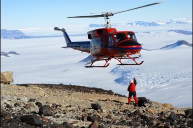  A helicopter airlifts a fossil-bearing rock from Antarctica back to camp. 