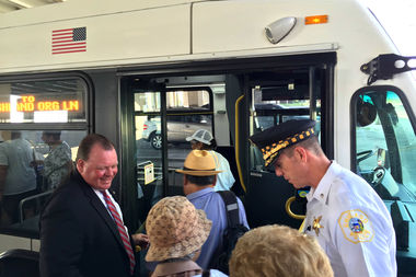  Ald. Patrick D. Thompson (11th) and Deering District Police Cmdr. Daniel Godsel welcome 11th Ward residents onto the reinstated No. 31 bus. 